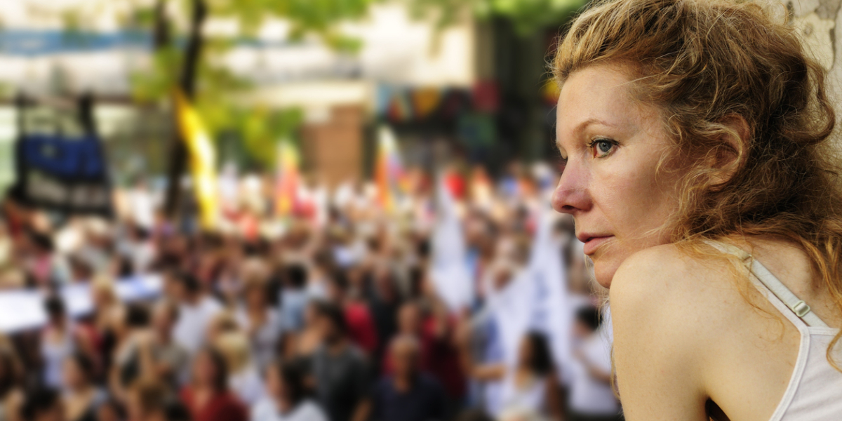 A woman looking out over a political demonstration or protest