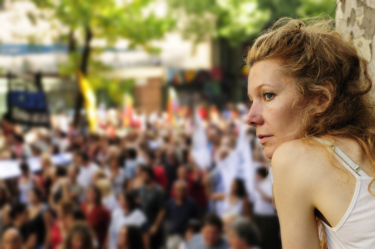 A woman looking out over a political demonstration or protest